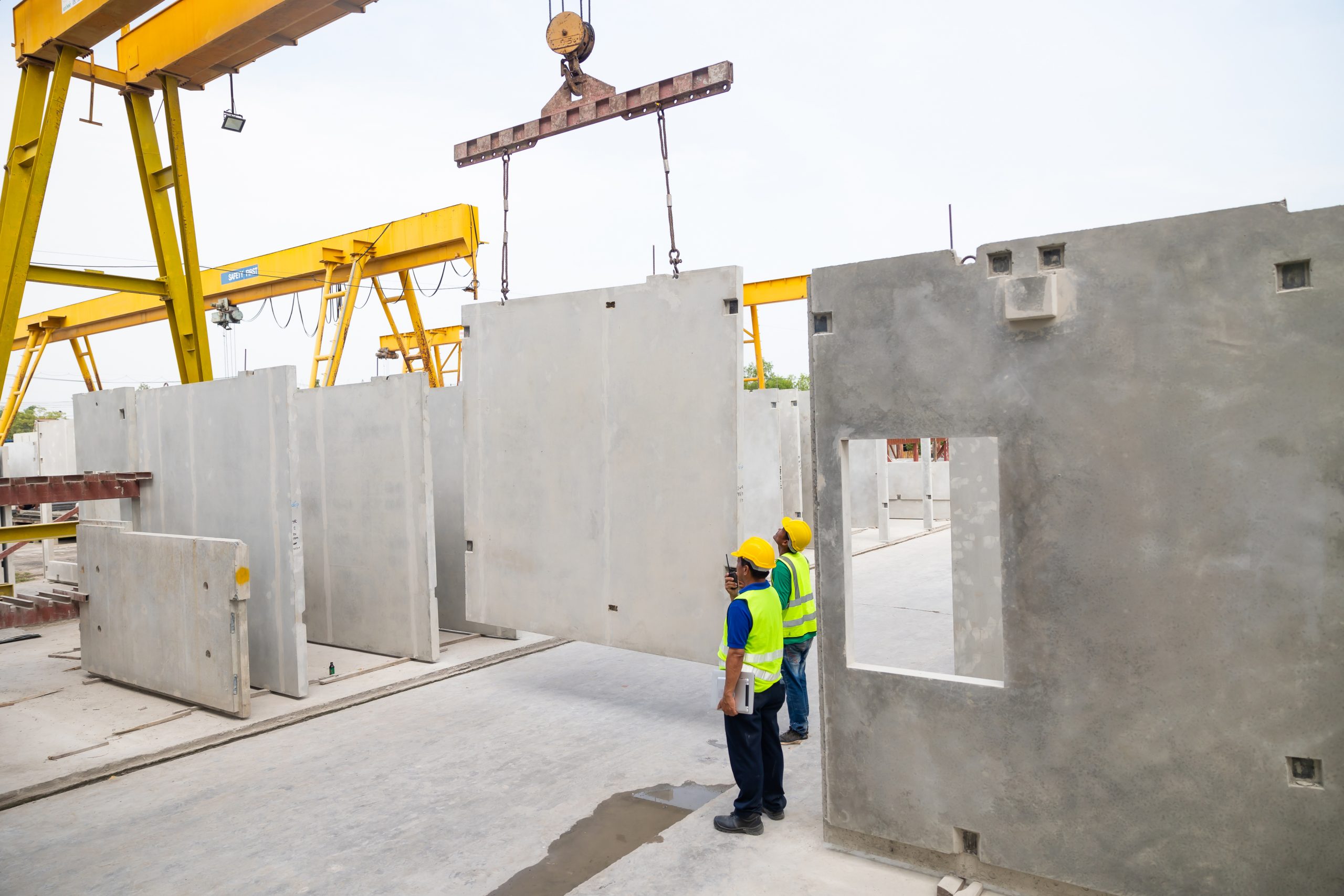 two construction workers looking at a tablet